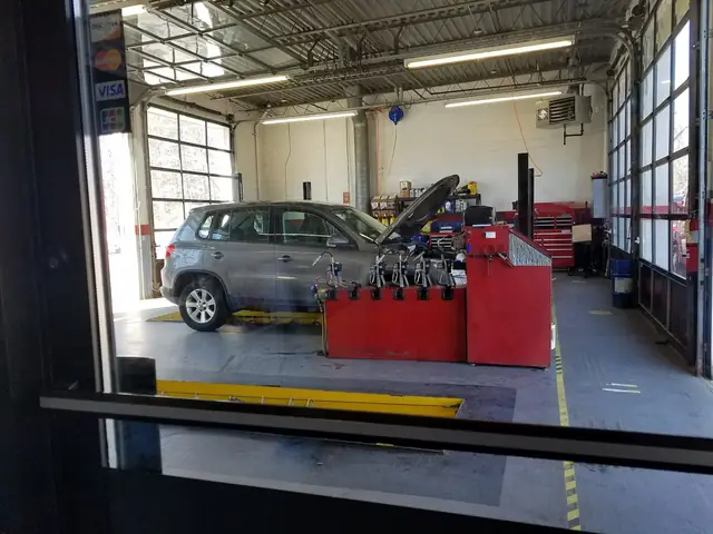 Looking into an Express Oil service bay with a car on the lift